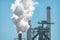 Smoke or steam emissions from steel mill factory - Industrial pollution concept