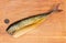 Smoked Atlantic mackerel without head on cutting board, top view