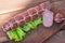 Smoked cutting salami on a old wooden table with green lettuce