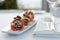 Smoked fish, sesame cheese ball and tapioca chips on restaurant table, close-up