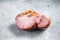 Smoked gammon - pork shoulder meat. Gray background. Top view