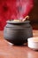 Smoked Matka biryani or handi biryani cook and serve in black clay pot on wooden table background garnish with rose petals