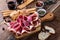 Smoked meat antipasto platter on rustic party table