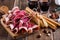 Smoked meat antipasto platter on rustic party table