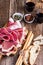 Smoked meat antipasto platter on rustic party table