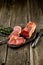 Smoked meat on wooden board with rosemary fork knife cuisine wooden texture