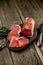 Smoked meat on wooden board with rosemary fork knife cuisine wooden texture