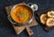 Smoked paprika vegetarian lentil soup with grilled cheese sandwiches a dark background, top view. Delicious comfort food concept
