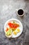 Smoked red fish salmon with olive, quail eggs, nuts and rice crispy cakes with avocado on a gray background. Top view. Rustic.