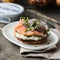 Smoked salmon bagels sandwich with soft cheese and micro greens on a cutting board