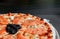 Smoked Salmon italian pizza with black Caviar close up shot