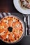 Smoked Salmon italian pizza with black Caviar close up top view