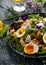 Smoked salmon and jammy soft-boiled free range egg and capers salad with edible borage and pansy flowers