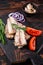 Smoked Sardine fish fillet on wooden board with herbs. Dark wooden background. Top view