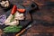 Smoked Sardine fish fillet on wooden board with herbs. Dark wooden background. Top view. Copy space