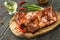 Smoked spiced juicy spareribs with red peppers, green onion and