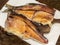 Smoked stockfish fish on a wooden board