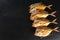 Smoked vomer fish on slate stone background. Mediterranean food, appetizer, seafood, close up