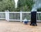 Smoker with fresh smoke coming out of BBQ cooker on outdoor deck