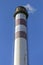 Smokestack against blue sky