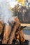 Smokey Stacked Logs in a Fire Pit