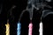 Smoking birthday candles on black