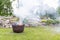 Smoking cauldron in a garden in summer