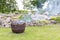 Smoking cauldron in a garden in summer