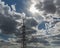 Smoking chimney of oil refinery against cloudy sky and sun