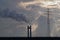 Smoking industry chimney and high voltage tower on dramatic cloudy sky