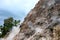 Smoking mountain rocks above green trees, volcanic island nature. Abstract mountain landscape with geyser smoke