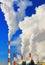 Smoking pipes of thermal power plant against blue sky