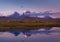 Smoking volcanos reflecting in the lake