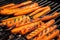 smoky and charred grilled carrots on a grill