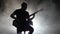 The smoky studio musician playing guitar sitting on a chair