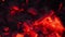 Smoldering embers of fire, live coals, burning charcoal in the background texture, closeup, glowing coal. Top view.