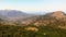 Smooth aerial flyover above mountains and woodland. Theme of tourism and hiking. Beautiful landscape. Drone 4K cinematic footage