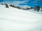 Smooth blanket of snow mountains and blue sky