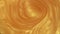 Smooth blending of golden glitter. A smooth whirlpool of gold paint in water