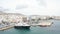 Smooth drone aerial view of yacht docked in port of Tinos in Greece.