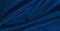 Smooth elegant blue silk or satin luxury cloth texture as abstract background. Luxurious Christmas background or New Year