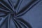 Smooth elegant blue silk or satin luxury cloth texture can be used as abstract background. Crumpled fabric Twisted at the side