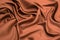 Smooth elegant brown silk satin textured fabric for using as abstract background for design
