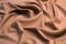 Smooth elegant brown silk satin textured fabric for using as abstract background for design.