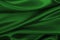 Smooth elegant green silk or satin luxury cloth texture as abstract background. Luxurious background design