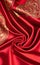 Smooth elegant red silk or satin luxury cloth texture as abstract background. Satin texture red and gold fabric.