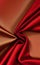 Smooth elegant red silk or satin luxury cloth texture as abstract background. Satin texture red and gold fabric.