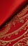 Smooth elegant red silk or satin luxury cloth texture as abstract background. Satin texture red and gold fabric.