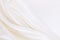 Smooth elegant white silk or satin luxury cloth texture as wedding background. Luxurious Christmas background or New Year