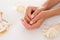 Smooth female hands holding a seashell, showing the beauty of manicure.